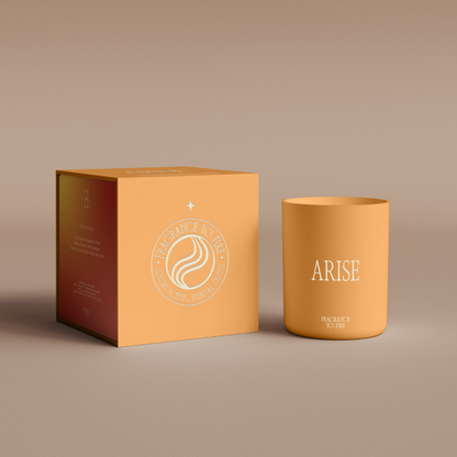 Yellow Arise candle on table, comforting soy wax candle for courage and grounding strength.